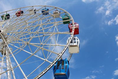 Low angle view of ferris wheel against blue sky