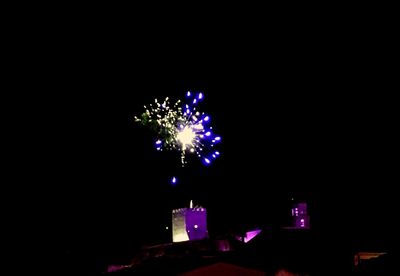 Low angle view of firework display at night