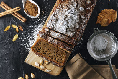 Pumpkin sponge cake cut into slices with powdered sugar on top