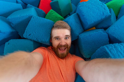 Portrait of happy man relaxing on sofa