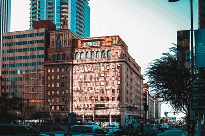 City street by buildings against sky