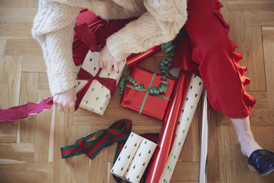 Woman's hands packing christmas presents