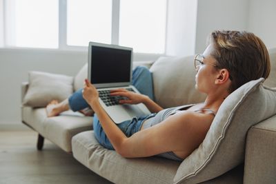 Young woman using laptop at home