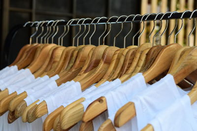 Close-up of clothes hanging in row