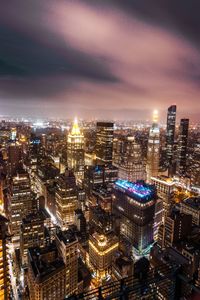 High angle view of illuminated cityscape against sky at dusk