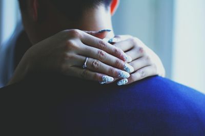 Close-up of woman embracing man