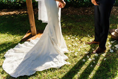 Low section of friends standing on field