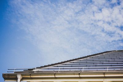 Low angle view of building roof against sky