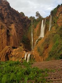 Scenic view of waterfall against sky