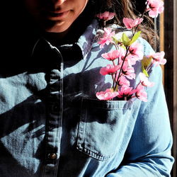 Midsection of woman holding flowering plant