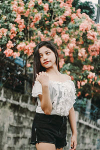 Portrait of beautiful young woman standing outdoors