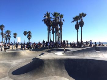 People watching man skateboarding at park