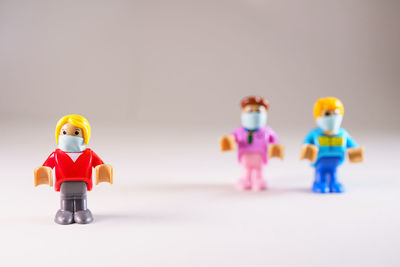 Close-up of toys on table against white background