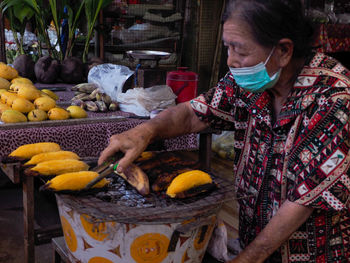 Rear view of woman holding food