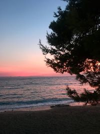 Scenic view of sea against clear sky at sunset