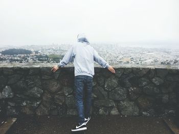 Full length of woman standing by railing