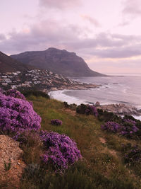 Scenic view of sea and mountains against sky during sunset