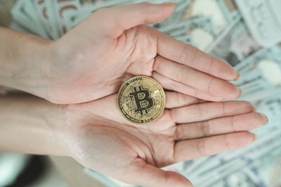 Cropped hand of person holding bitcoin