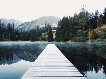 Pier over lake against sky