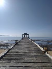 Pier over sea against clear sky