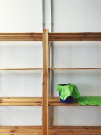 Close-up of open window on wooden floor against wall at home