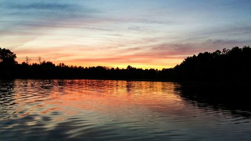 Scenic view of lake at sunset
