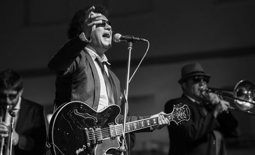 Close-up of man playing guitar