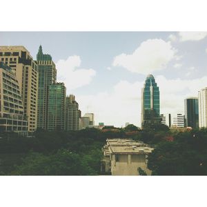 Buildings against cloudy sky