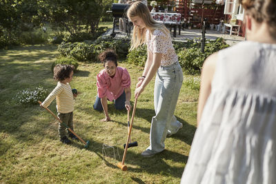 Family playing croquet in garden