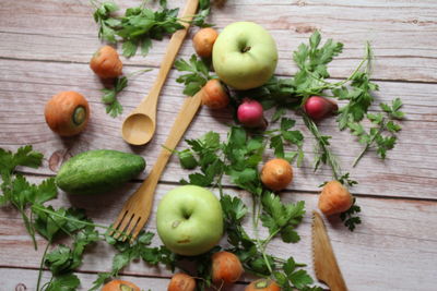 High angle view of fruits and leaves on table