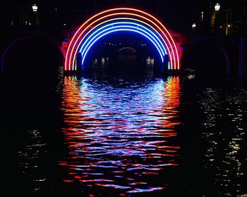 Illuminated lights against sky at night