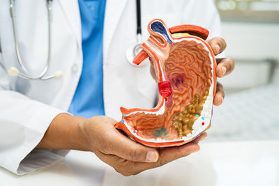 Midsection of doctor examining patient