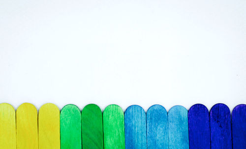 Close-up of multi colored pencils against white background