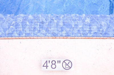 High angle view of text on wall by swimming pool