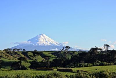 Scenic view of mountains against blue sky