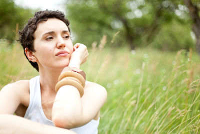 Closeup portrait of cute girl on green field