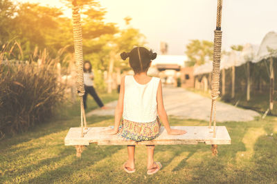 Rear view of woman on swing