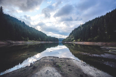 Scenic view of lake and mountains against sky