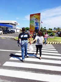 Rear view of man standing on road