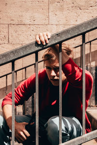 Man sitting on railing