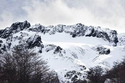 Scenic view of snow covered mountains against sky