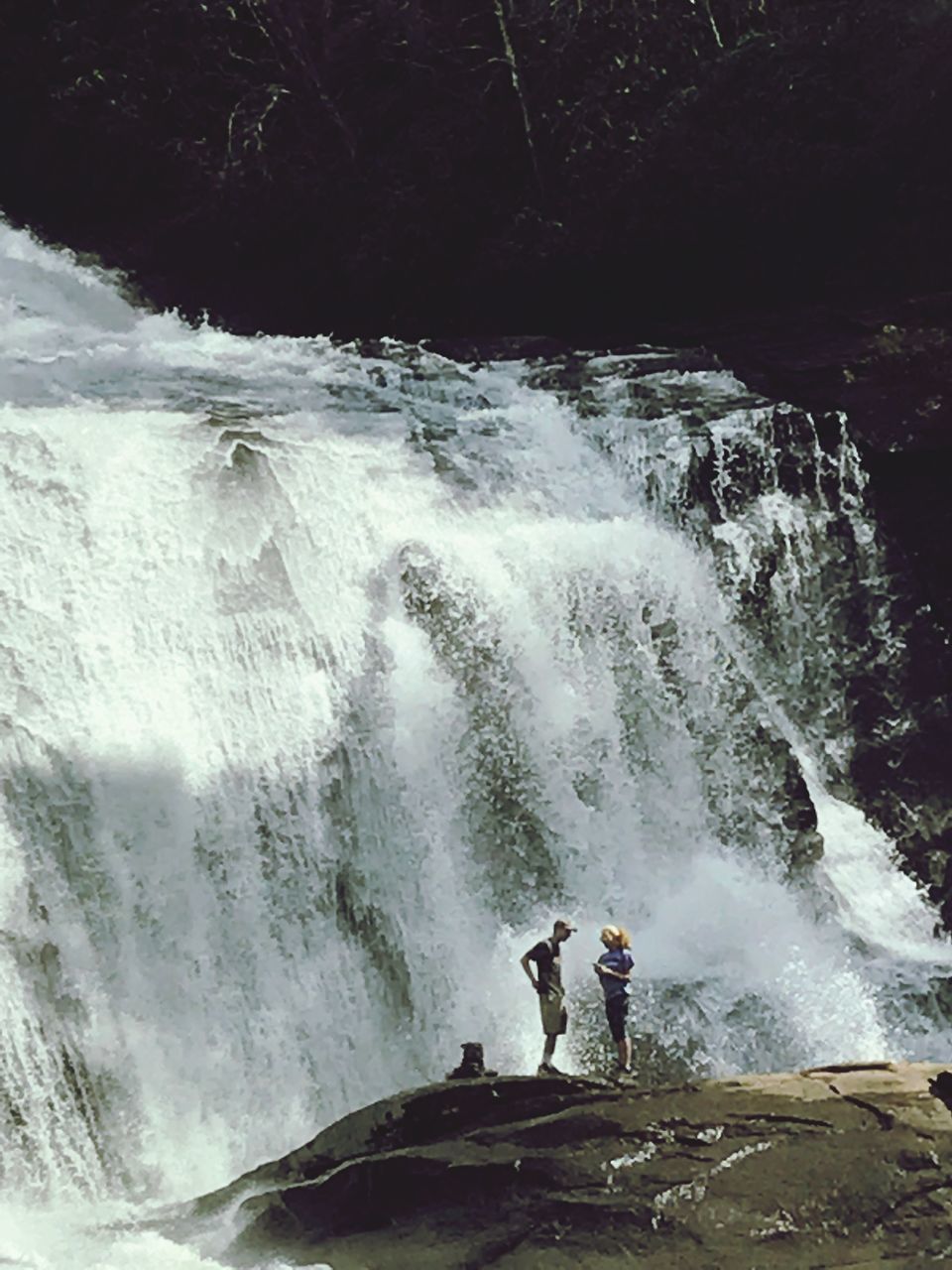 PEOPLE STANDING IN WATERFALL