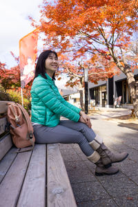 Full length of woman sitting in park