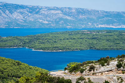 High angle view of sea and mountains against sky