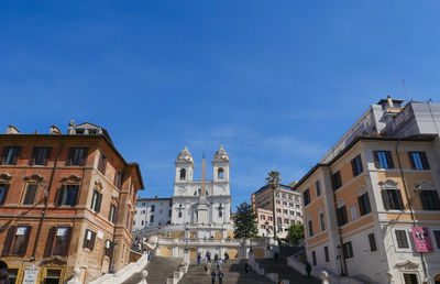 Low angle view of buildings against clear blue sky