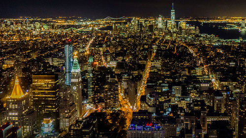 High angle view of city lit up at night