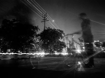 Electricity pylon against sky at night