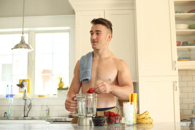 Mid adult man standing in kitchen