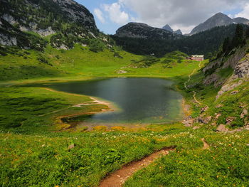 Scenic view of lake and mountains against sky