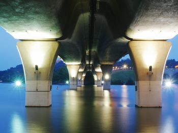 Illuminated bridge against sky at night